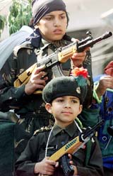Children dressed as militants and security personnel participate in a peace rally in Jammu