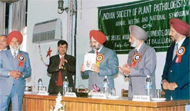 Dr K.S. Aulakh, Vice-Chancellor, PAU, releases souvenir on the Indian Society of Plant Pathologists in Ludhiana 