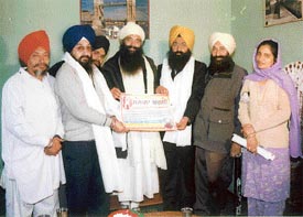 The area councillor, Mr Rajinder Singh Bhatia, and a Youth Akali Dal activist, MrJatinder Singh Gilhotra, being honoured at a religious congregation in Ludhiana