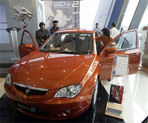 Visitors look at the newly launched GEN-2 model by national carmaker Proton in Kuala Lumpur