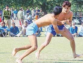 Kabaddi players of India (red) and India (blue) vie with each other at the 16th National Circle Kabaddi Tournament, which began at the Sector 17 football stadium, Chandigarh, on Friday. 