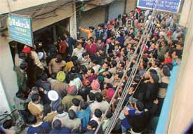 Angry traders outside KS Trading Company at Mochpura Bazar in Ludhiana where they gheraoed four excise officials who had come to conduct