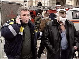 An injured person is led by a rescue worker from the Avtozovodskaya metro station in Moscow 