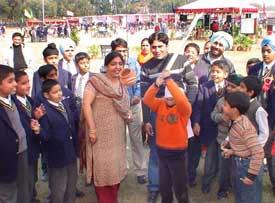 Children take part in a fun game at a fete organised at Yadavindra Public School