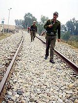 Security personnel keep vigil on the Jammu-Udhampur railway track to be made functional from March 25 this year
