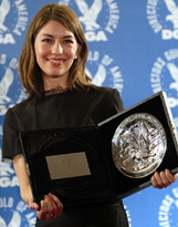 Director Sophia Coppola poses backstage with the nominee medallion she recieved for her film Lost in Translation