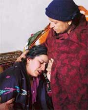 Kanchan, wife of Anil Sharma, alias Lalla, being consoled by a relative in Ludhiana on Monday.