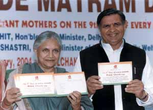 Delhi Chief Minister Sheila Dikshit displaying the maternity card that would enable women to have a free check up once a month
