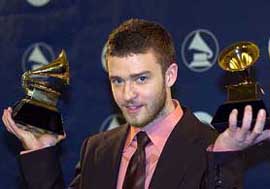 Justin Timberlake holds the awards he won for best male pop vocal performance and best pop vocal album at the 46th annual Grammy Awards