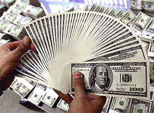 US dollars notes are checked at the Korean Exchange Bank in Seoul 