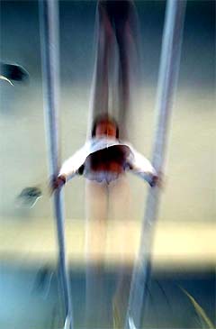 A six-year-old Chinese boy practices on parallel bars at Beijing's Shishahai Sports School 