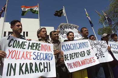 Pakistani cricket fans hold placards