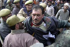 Policemen nab a protester during a demonstration in Srinagar on Friday against the killing of civilians in Bandipora