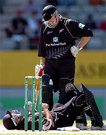 New Zealands Craig McMillan lies on the ground after being hit by a ball from team-mate Scott Styris who stands over him