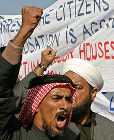 An Iraqi man raises anti-US slogans