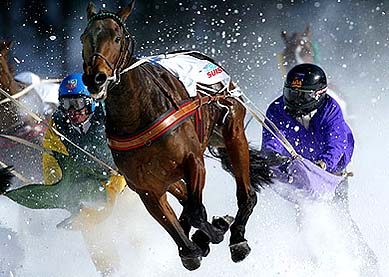 Skiers are pulled by horses in the skijoering White Turf horse racing event in St. Moritz