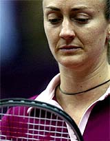 Mary Pierce of France reacts after losing a point to Kim Clijsters of Belgium
