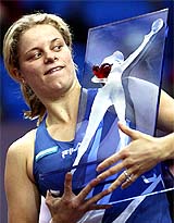 Kim Clijsters of Belgium holds up her trophy after winning the Paris Open WTA tournament in Paris 