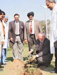 Dr Thomas Gallagher, Director of National Institutes of Health Office of Community Liaison, plants a sapling at Fortis Healthcare, Mohali