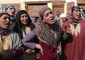 Relatives of Ghulam Mohammed, a politician with PDP, wail outside his residence in Srinagar on Monday. Militants killed Ghulam in Srinagar.
