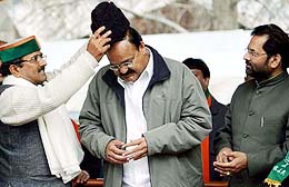 BJP President Venkaiah Naidu is honoured with a Kashmiri Krakul by BJP state President Nirmal Singh at a rally in Srinagar on Wednesday.