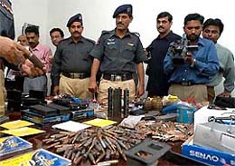 Police officers display ammunition they confiscated from militants in Karachi 