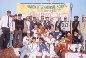 The Salwan Boys School team, who won the Ganga Cup Cricket Tournament, with principal H. S. Srow and manager S. K. Gupta, on the school premises