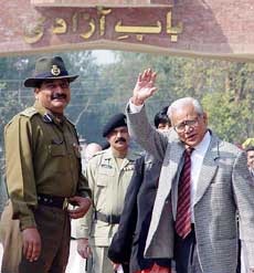 Chief Justice of India V.N. Khare waves to reporters before entering the Pakistan side of the India-Pakistan joint checkpost at Wagah