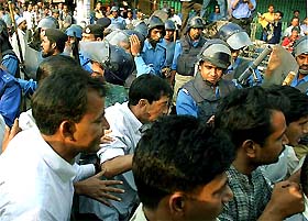 Bangladeshi policemen disperse opposition protesters in Dhaka