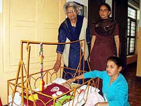 Khushi, the three-month-old child with calcification in kidney, with the women who have been looking after her at Jalandhar’s Pushpa Gujral Nari Niketan
