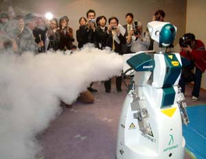 A security robot called T63 Aptemiz, named after Artemis, sprays smoky fog as a robot making venture company, Tmsuk, announces the company will start to rend out the robot at a rate of three million yen ($ 28,600) per year from April, in Kitakyushu, Japan.