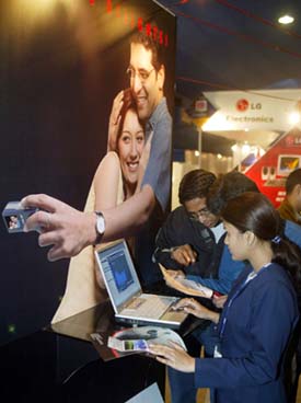 An Indian exhibitor shows visitors the features of a laptop at eastern India’s biggest computer exhibition in Kolkata.
