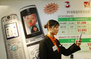 A promoter demonstrates a 3G video mobile phone at a Hutchison service centre in Hong Kong.