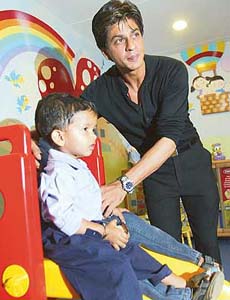 Shah Rukh Khan plays with a child in the Blessed Mother Teresa Paediatric Centre at a hospital in Mumbai