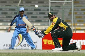 Pakistani blind cricketer Fayaz sweeps the ball during their second one-day match against India 