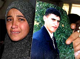 A relative holds a picture of Palestinian suicide bomber Mohammed Zaal at a village near Bethlehem 