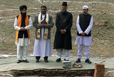 A Sikh granthi, a Christian father, a Muslim moulabi and a Hindu priest pose together during the foundation stone-laying ceremony for an 'all faith complex', to be built by the Indian Army