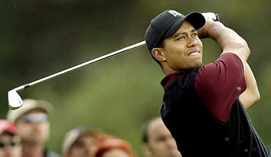World number one golfer Tiger Woods hits his tee shot on the par three 16th hole, during the final round of the Nissan Open in Los Angeles