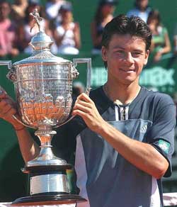 Argentine Guillermo Coria holds the cup after his victory over Carlos Moya of Spain, during the final of the ATP Tennis Tournament