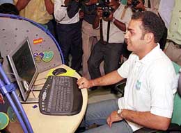 Star cricketer and Reliance Infocomm Brand Ambassador Virendra Sehwag checks out broadband internet 
