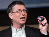 Microsoft Chairman Bill Gates holds an RSA security tag in San Francisco on Tuesday. Office computers running the latest Windows operating systems could get a new degree of protection against hackers from a partnership announced by Microsoft Corp. and RSA Security Inc. 
