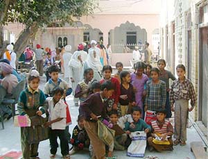 Students of a primary school in Gurdaspur study on a gurdwara premises where marriages and other ceremonies are a routine affair.