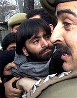 Mohammad Yasin Malik, chairman of the JKLF, is detained by the police in Srinagar 