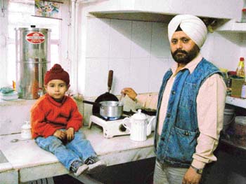 Chandigarh-based lawyer Harpal Singh makes lunch and takes care of son Tajeshwar.
