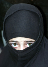 A Kashmiri Shia Muslim girl watches a Moharram procession