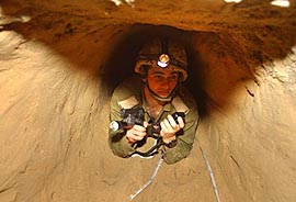 An Israeli soldier inspects the tunnel