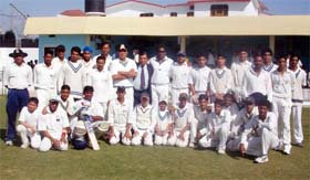 Chandigarh Cricket Academy and Samrala XI players with former Test player Yog Raj Singh and Sushil Kapoor, Manager, Punjab Ranji team, pose before a match at Samrala