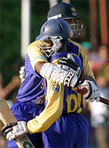 Sri Lankas Nuwan Zoysa and Russel Arnold celebrates their three-wicket victory over Australia in the fifth and final one-day international cricket match in Colombo