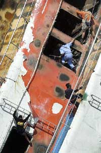 Rescue workers struggle to get inside the burnt bridge of the Superferry 14 