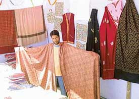A craftsman from Srinagar displays pashmina shawls during the Northern and North Eastern Zone Khadi Gramodyog Expo, which opened in Chandigarh